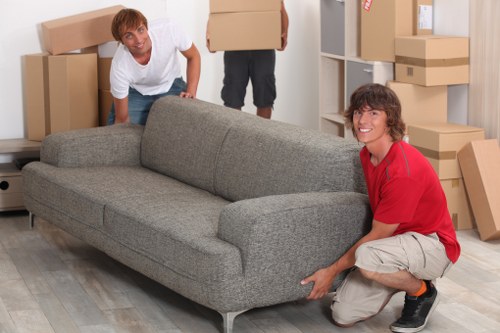Furniture being moved through a narrow Soho staircase