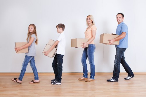 Professional movers planning a home relocation in Soho near busy streets and mixed-use buildings