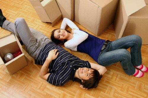 Local removal team carrying furniture in a central London property