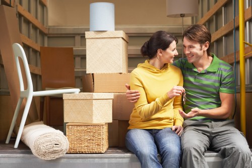 Mover carrying an item carefully through a narrow interior space